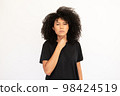 Portrait of displeased young woman touching throat 98424519
