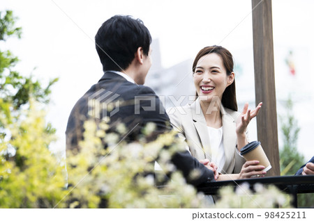 A woman in a suit chatting A woman in a suit chatting 98425211