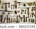 Pegboard wall filled with hanging tools 98425348