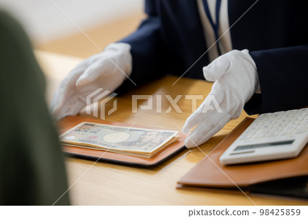 A woman appraising a watch A woman appraising a watch 98425859
