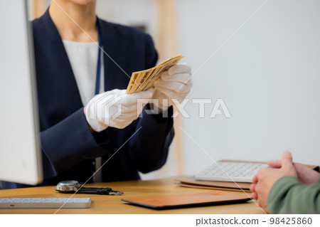 A woman appraising a watch A woman appraising a watch 98425860