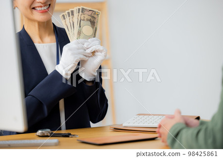 A woman appraising a watch 98425861