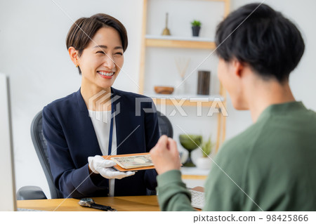 A woman appraising a watch 98425866