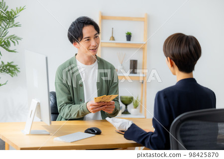 A woman appraising a watch 98425870