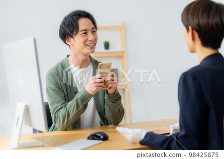 A woman appraising a watch 98425875