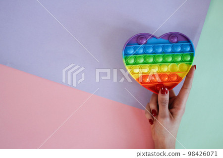Woman holding antistress sensory pop it toy 98426071