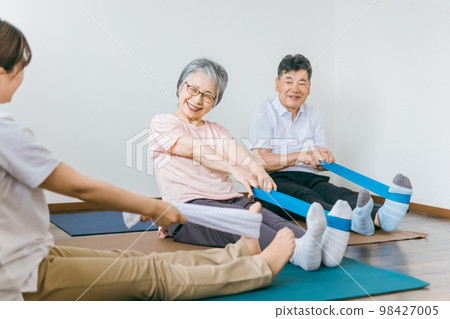 Senior and elderly men and women who train and rehabilitate tube training at nursing homes and physical therapists, caregivers, and trainers 98427005