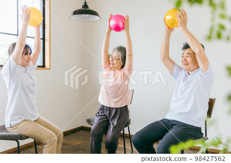 在療養院進行球類體操、鍛煉和康復的老年男性和女性，以及物理治療師、護理人員和培訓師 98427562