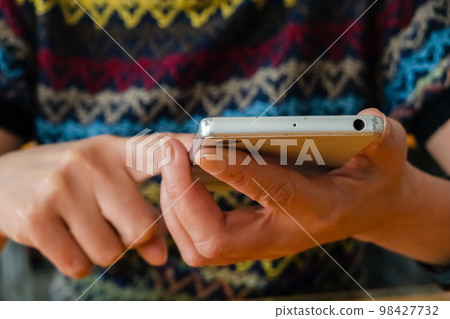 woman using smartphone woman using smartphone 98427732