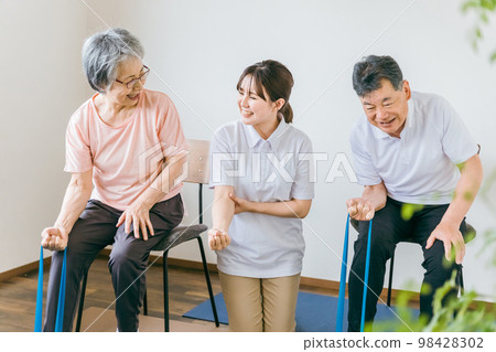 Senior and elderly men and women who train and rehabilitate tube training at nursing homes and physical therapists, caregivers, and trainers 98428302