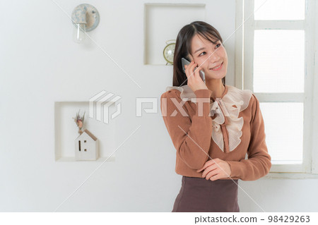 Women calling on a smartphone Women calling on a smartphone 98429263