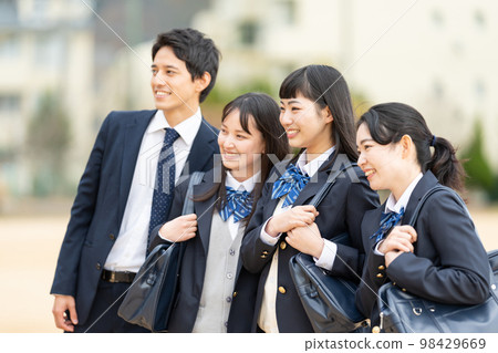 High school girls and boys lined up in the schoolyard High school girls and boys lined up in the schoolyard 98429669