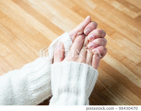 A woman's hand swollen with frostbite and chapped hands A woman's hand swollen with frostbite and chapped hands 98430470