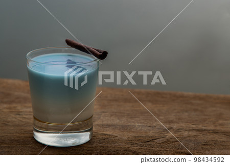 A glass of Blue matcha latte tea or Butterfly pea flower milk tea latte from the dried flowers of the butterfly pea plant (clitoria). 98434592
