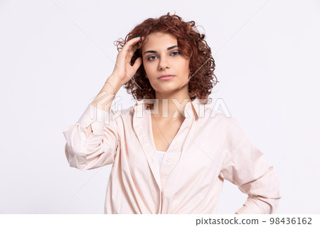 Portrait of a girl with a serious expression on her face. Short curly hair. Portrait of a girl with a serious expression on her face. Short curly hair. 98436162