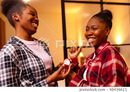 african american woman making proposal to her girlfriend while they have romantic evening date african american woman making proposal to her girlfriend while they have romantic evening date 98436621