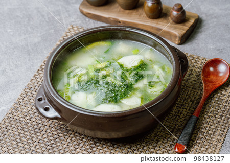 Korean food Mesaengi Tteokguk dish served in a black earthen pot 98438127