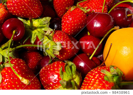 Ripe tasty berries apricot, sweet cherry, strawberry close up. Top view Ripe tasty berries apricot, sweet cherry, strawberry close up. Top view 98438961