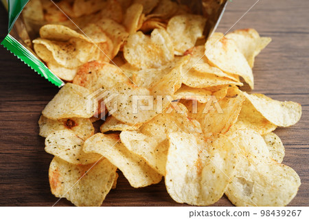 Potato chips in open bag, delicious BBQ seasoning spicy for crips, thin slice deep fried snack fast food in open bag. Potato chips in open bag, delicious BBQ seasoning spicy for crips, thin slice deep fried snack fast food in open bag. 98439267