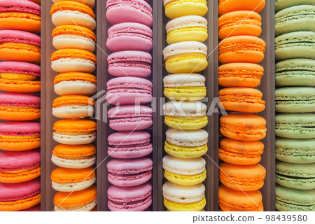 Colorful sweet cookies on the cafe showcase. 98439580