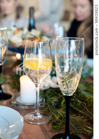 two glasses with alcohol on the New Year's table. glass of champagne and cocktail with lemon in a glass 98439823