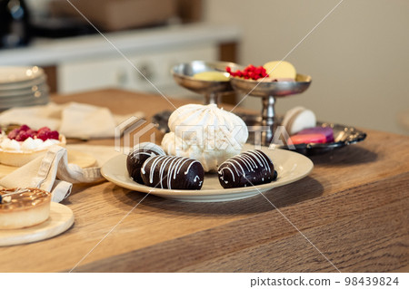 potato cake and meringue on the table.Sweet table on holiday potato cake and meringue on the table.Sweet table on holiday 98439824
