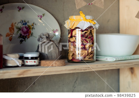 dried apples in a jar and jam on a shelf. Rustic food shelf dried apples in a jar and jam on a shelf. Rustic food shelf 98439825