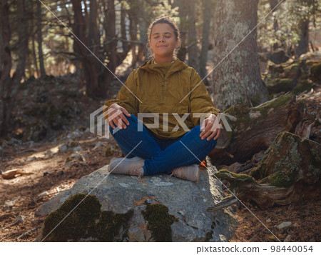 caucasian woman enjoys being in nature, 98440054