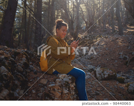 caucasian woman enjoys being in nature, 98440063