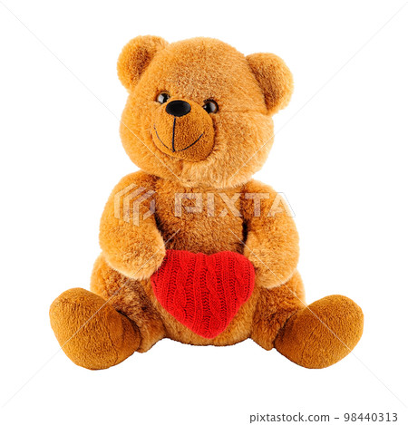 Soft toy teddy bear holding a heart-shaped pillow isolated 98440313