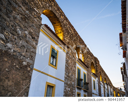 Picturesque view of Evora and its traditional white houses incorporated in the arches of Prata aqueduct, Alentejo region, Portugal 98441957