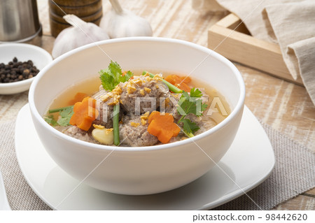 Close up Clear glass noodle soup with Minced Pork and carrot.Asian Meatball Soup with cellophane noodle (Gaeng Jued Woon Sen) 98442620