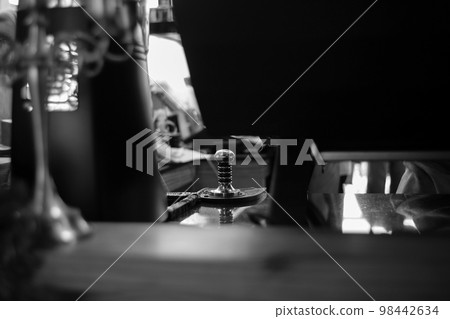 Selective focus on the metal equipment for manually pressing the coffee powder for making the fresh coffee at the cafe. Selective focus on the metal equipment for manually pressing the coffee powder for making the fresh coffee at the cafe. 98442634
