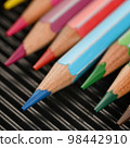 Colored pencils for drawing on a black background 98442910