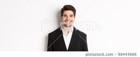Close-up of handsome young businessman in trendy suit smiling, standing against white background Close-up of handsome young businessman in trendy suit smiling, standing against white background 98443666