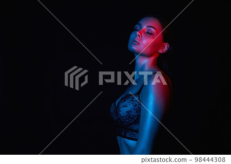 young woman in Underwear. Beautiful sexy Girl in color lights young woman in Underwear. Beautiful sexy Girl in color lights 98444308