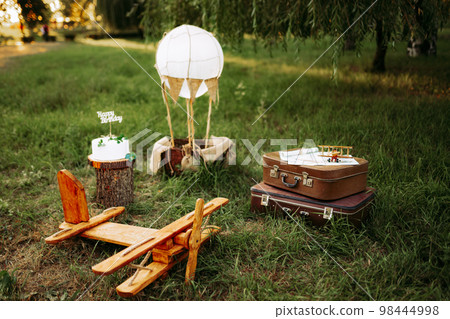 Happy birthday concept. Decorating for little pilots, travelers. Toy plane with airbaloon outdoor Happy birthday concept. Decorating for little pilots, travelers. Toy plane with airbaloon outdoor 98444998