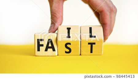 Fail fast symbol. Concept words Fail fast on wooden cubes. Businessman hand. Beautiful yellow table white background. Business and fail fast concept. Copy space. Fail fast symbol. Concept words Fail fast on wooden cubes. Businessman hand. Beautiful yellow table white background. Business and fail fast concept. Copy space. 98445413