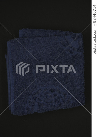 A cloth for wiping. Purple cloth on a black background. Towel. 98446714