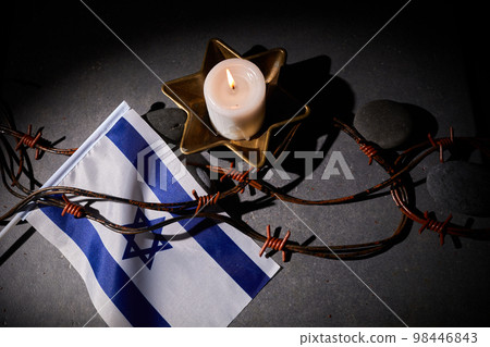 Burning candle, Barbed wire, flag of Israel on dark background. Holocaust memory day Burning candle, Barbed wire, flag of Israel on dark background. Holocaust memory day 98446843