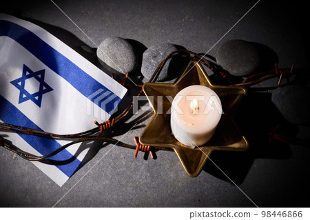 Burning candle, Barbed wire, flag of Israel on dark background. Holocaust memory day Burning candle, Barbed wire, flag of Israel on dark background. Holocaust memory day 98446866