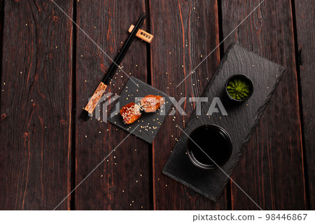 Japanese sushi unagi nigiri sushi smoked eel on wooden background top view Japanese sushi unagi nigiri sushi smoked eel on wooden background top view 98446867
