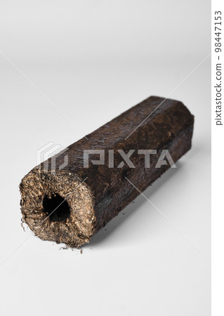Wooden pressed briquette Pini Kay from biomass on a white Wooden pressed briquette Pini Kay from biomass on a white 98447153