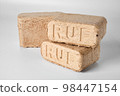 Wood briquettes (ruf type), made of beech and oak burning inside the wood fuel boiler. 98447154