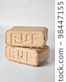 Two wooden briquettes (ruf type) on white background. 98447155