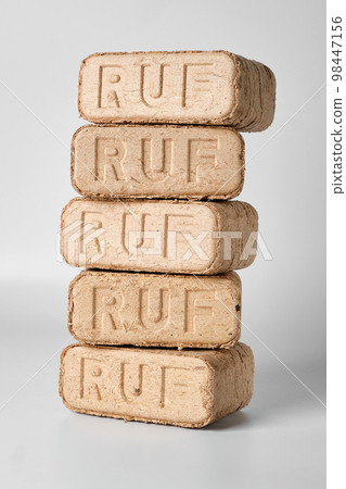 Five wooden briquettes (ruf type) on white background. Five wooden briquettes (ruf type) on white background. 98447156