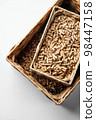 Wooden pellets in two wicker boxes. Biomass fuel 98447158