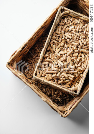 Wooden pellets in two wicker boxes. Biomass fuel Wooden pellets in two wicker boxes. Biomass fuel 98447158