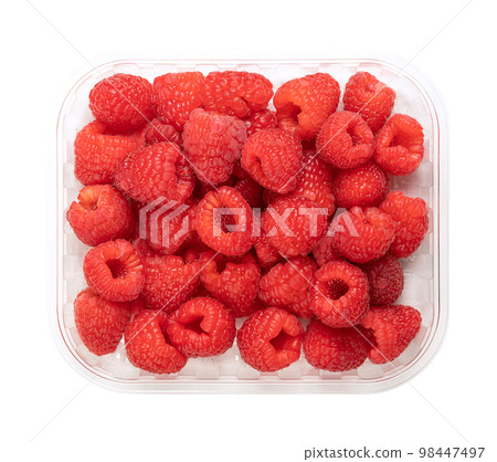 Whole fresh raspberries, in a clear plastic punnet, from above. Ripe, red and sweet fruits of Rubus idaeus, the cultivated European raspberry. Organic and vegan fruits. Isolated, close-up, food photo. 98447497
