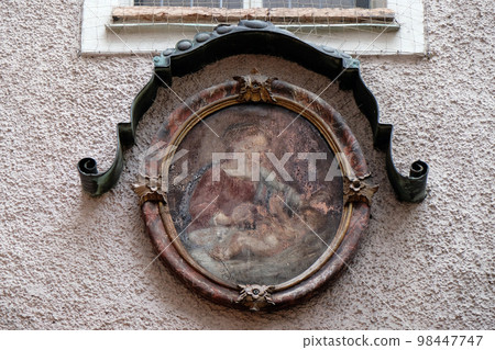 Virgin Mary with baby Jesus painting on house facade in Salzburg 98447747